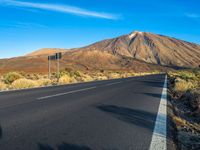 the highway in the mountains goes on a steep hill side next to a road with a single lane