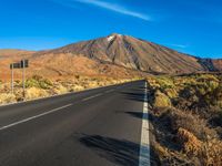 the highway in the mountains goes on a steep hill side next to a road with a single lane