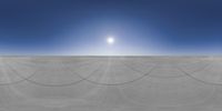 the sun shines brightly above a vast expanse with long, thin, lines of sand covering it