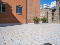 this brick courtyard is very neat and neat for use in an urban setting as well as surrounding buildings