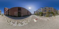 a photo taken from a fish eye lens shows a skateboard that is laying on the ground