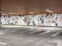 an empty parking lot with painted wallpaper on the walls, and some concrete flooring