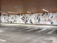 an empty parking lot with painted wallpaper on the walls, and some concrete flooring