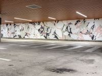 an empty parking lot with painted wallpaper on the walls, and some concrete flooring