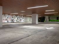 the inside of an empty parking garage area with white arrows pointing in all directions on the walls