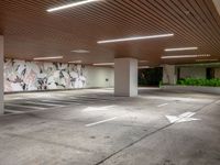 the inside of an empty parking garage area with white arrows pointing in all directions on the walls