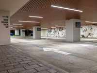 an empty parking lot with a colorful mural on the walls and ceilings above the floor