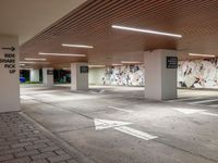 an empty parking lot with a colorful mural on the walls and ceilings above the floor