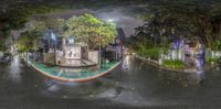 a view of a city at night with a house boat and trees outside in the rain