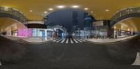 a curved walkway with a sky bar in the middle of it and a building that looks like a train station in the background