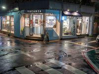 a bus is parked in front of a pharmacy on the street while rain starts to fall