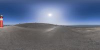 a 360 - view is displayed of the ground and light poles with a sun shining in the sky behind them