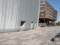 a concrete block walkway between two buildings near one another with a skateboard on it