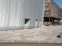 a concrete block walkway between two buildings near one another with a skateboard on it