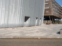 a concrete block walkway between two buildings near one another with a skateboard on it