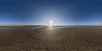 a beach view taken from the fish eye of a beach under a bright blue sky