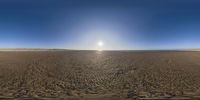 the view from a small beach as the sun sets over a wide expanse of sand