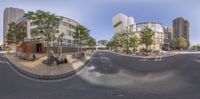 a fisheye lens photo of a city street and buildings, seen in the foreground