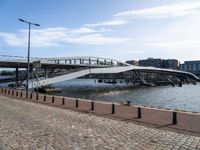 this photo shows the walkway across the canal on the side of the river as well as the footbridge