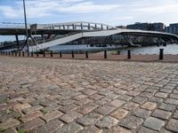 this photo shows the walkway across the canal on the side of the river as well as the footbridge