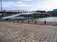 this photo shows the walkway across the canal on the side of the river as well as the footbridge