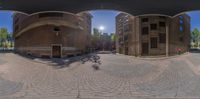 an image of a city street from a fish eye lens view of a building with a bike parked at the corner