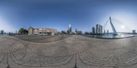 an image of a fish eye view from the water area of a city at sunrise