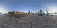 a fish - eye view of a city and the river and bridge from a circle