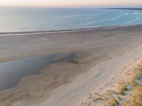 a beach and sky view with no people or vehicles on it's side with a reflection on the beach