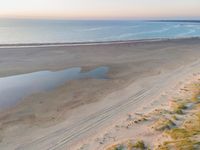 a beach and sky view with no people or vehicles on it's side with a reflection on the beach