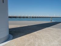 the boat ramp that is being extended along the river bank has an ocean view of large boats