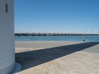 the boat ramp that is being extended along the river bank has an ocean view of large boats