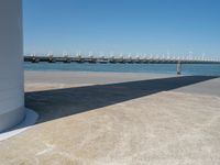 the boat ramp that is being extended along the river bank has an ocean view of large boats