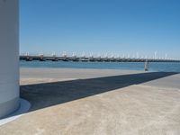 the boat ramp that is being extended along the river bank has an ocean view of large boats