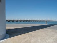 the boat ramp that is being extended along the river bank has an ocean view of large boats