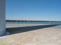 the boat ramp that is being extended along the river bank has an ocean view of large boats