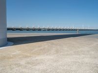 the boat ramp that is being extended along the river bank has an ocean view of large boats