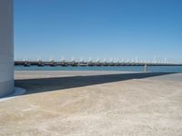 the boat ramp that is being extended along the river bank has an ocean view of large boats