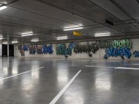 several cars parked in an underground parking lot with graffiti on the walls and ceiling and floor