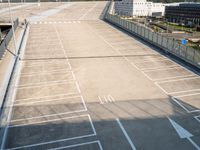 an empty parking lot with lights on each of the entrances and side lines on the side