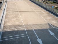 an empty parking lot with lights on each of the entrances and side lines on the side