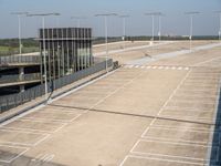 an empty parking lot with lights on each of the entrances and side lines on the side