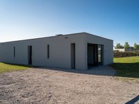 a small building on an empty lot, with no one inside it or behind it