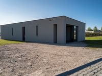 a small building on an empty lot, with no one inside it or behind it