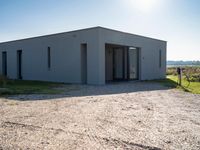 a small building on an empty lot, with no one inside it or behind it