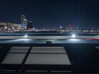 an image of parking lot lights in city at night time shot from the top of building in city