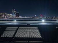 an image of parking lot lights in city at night time shot from the top of building in city