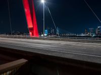 view of bridge with city skyline in background at night - like scene at dusk or on the night