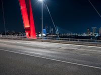 view of bridge with city skyline in background at night - like scene at dusk or on the night