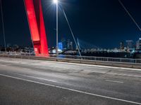 view of bridge with city skyline in background at night - like scene at dusk or on the night